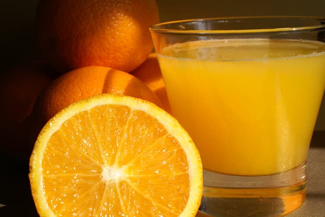 photo of orange juice and slices
